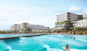 a person riding a surfboard in a body of water at Beachfront Condo/ Pool/ Surfing/ Fishing / EW 1202 in Virginia Beach