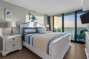 a bedroom with a bed with a view of the ocean at Beachfront Condo/ Pool/ Surfing/ Fishing / EW 1202 in Virginia Beach +51 photos