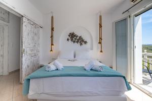 a bedroom with a large bed with towels on it at 7Days-Suite & SeaView in Agkidia +25 photos