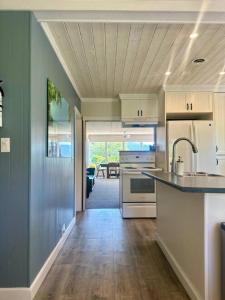 a kitchen with a sink and a counter top at Captain Cottage in Bowen Island
