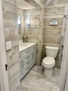 a bathroom with a toilet and a sink at Captain Cottage in Bowen Island +26 photos