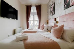 a hotel room with two beds and a television at Mina Hotel by PLI in London
