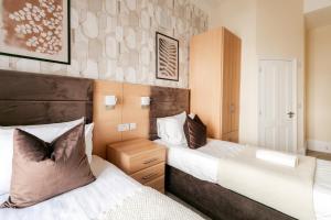 a bedroom with two beds at Mina Hotel by PLI in London