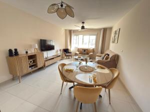 a dining room and living room with a table and chairs at Apartamento céntrico junto paseo, playas y zonas de interés!! in Águilas