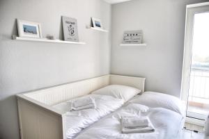 a room with two beds with white sheets at Lagunenstadt am Haff - Fewo 093 Ree! in Ueckermünde +16 photos