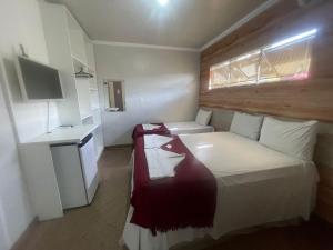 a small room with a bed and a small kitchen at Pousada Maré Alta in Maceió