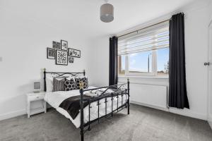 a bedroom with a bed and a window at Troon Golf by the Sea in Troon