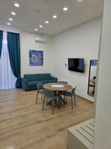 a living room with a table and chairs and a couch at Toto e Peppino Luxury Rooms in Naples