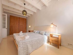 a bedroom with a bed with two towels on it at Can Borras by 3VILLAS in Llumesanas