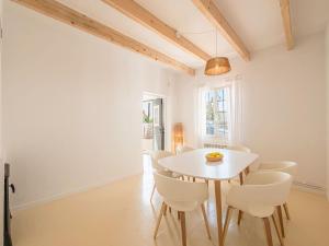 a white dining room with a white table and chairs at Can Borras by 3VILLAS in Llumesanas +36 photos