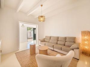 a living room with a couch and a table at Can Borras by 3VILLAS in Llumesanas