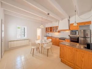 a kitchen with a table and chairs in it at Can Borras by 3VILLAS in Llumesanas