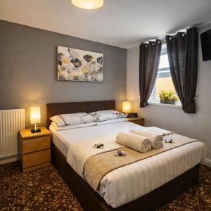 a bedroom with a large bed and a window at Denville Hotel in Blackpool