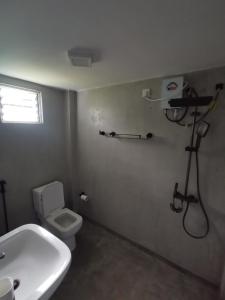 a bathroom with a toilet and a sink and a shower at Villa Rina in Kottagoda +12 photos