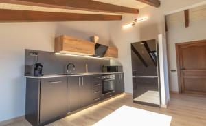 a kitchen with gray cabinets and a sink at el Niuet All in All