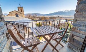 a wooden table and two chairs on a balcony at el Niuet All in All