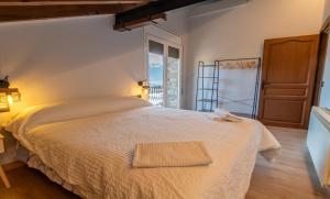 a bedroom with a large bed and a window at el Niuet All in All