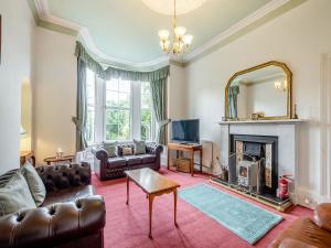 a living room with a couch and a fireplace at Springvale in Cardross