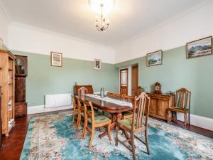 a dining room with a table and chairs at Springvale in Cardross +23 photos