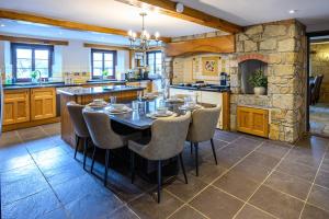 a large kitchen with a table and chairs at Laurel House - Pool, Sauna & Gardens - Sleeps up to 12 people by STAE-Homes in Magor +48 photos