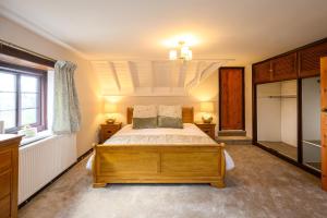 a bedroom with a bed and a window at Laurel House - Pool, Sauna & Gardens - Sleeps up to 12 people by STAE-Homes in Magor