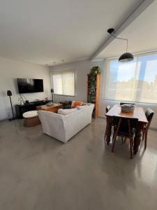a living room with a couch and a table at Depto Berazategui Centro in Berazategui