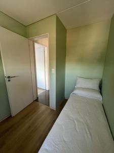 an empty room with two beds and an open door at Depto Berazategui Centro in Berazategui