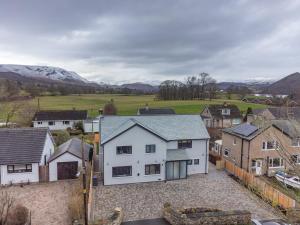an aerial view of a white house in a village at Elder howe in Penrith