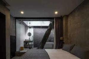 a bedroom with a large bed and a large window at My loft ChengDu in Chengdu