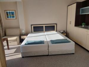 a bedroom with a large white bed in a room at Berlin Golden Beach Studio in Varna City