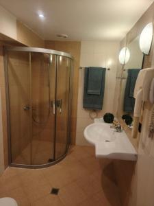a bathroom with a shower and a sink at Berlin Golden Beach Studio in Varna City +4 photos