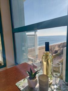 a table with a bottle of wine and two glasses at Berlin Golden Beach Studio in Varna City