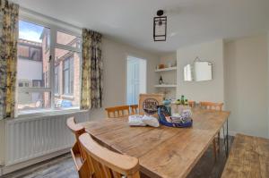 a dining room with a wooden table and chairs at 5 Bed in Southwold oc-hjames in Southwold +10 photos