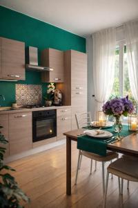 a kitchen with a table and a dining room at Enjoy Home Sorrento in Sorrento