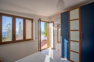 a room with a door and windows with a view at CAPOVILLAS - Villa Laura with private pool in Vibo Valentia +31 photos