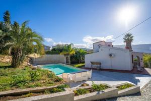 a villa with a swimming pool in front of a house at CAPOVILLAS - Villa Laura with private pool in Vibo Valentia