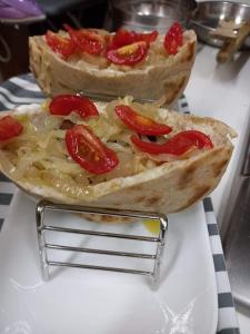 two pizzas with tomatoes on top on a counter at Moktan Homestay in Pakhyong