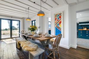a dining room with a wooden table and chairs at 5 Bed in Walberswick oc-lev in Walberswick