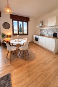 a kitchen and dining room with a table and chairs at Bella Vista Baveno in Baveno +9 photos
