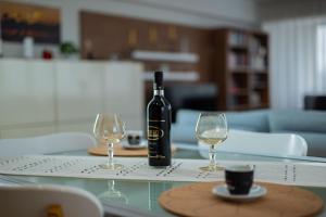 a bottle of wine sitting on a table with two glasses at Petra's Skyline in Suceava