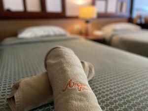 a towel laying on top of a bed at อัมพวาริเวอร์วิว Amphawa River View in Samut Songkhram