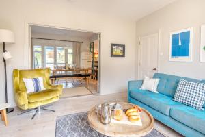 a living room with a blue couch and a table at 4 Bed in Walberswick oc-hwfern in Walberswick +16 photos