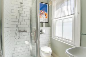 a bathroom with a shower and a toilet and a sink at 4 Bed in Walberswick oc-hwfern in Walberswick