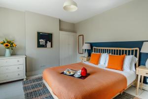 a bedroom with a bed with a tray of food on it at 4 Bed in Walberswick oc-hwfern in Walberswick