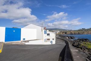 a white and blue building on the side of a road at GuestReady - Sea Escape Azores in Lagoa