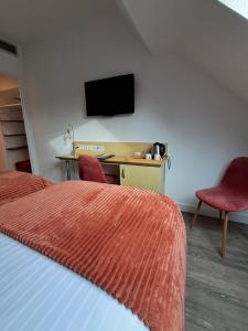 a hotel room with two beds and a desk with a television at Best Western Le Vinci Loire Valley in Amboise