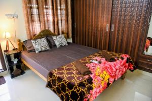 a bedroom with a large bed in a room at Aura attic residency in Bangalore