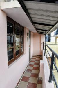 a balcony of a building with a checkerboard floor at Aura attic residency in Bangalore