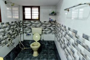 a bathroom with a toilet and a shower at Aura attic residency in Bangalore +13 photos