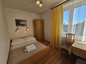 a bedroom with a bed and a table and a window at Hotel Eden 24h in Rzeszów +48 photos